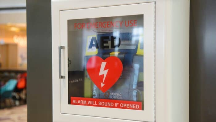 AED machine posted up on a wall in a safe location in California.