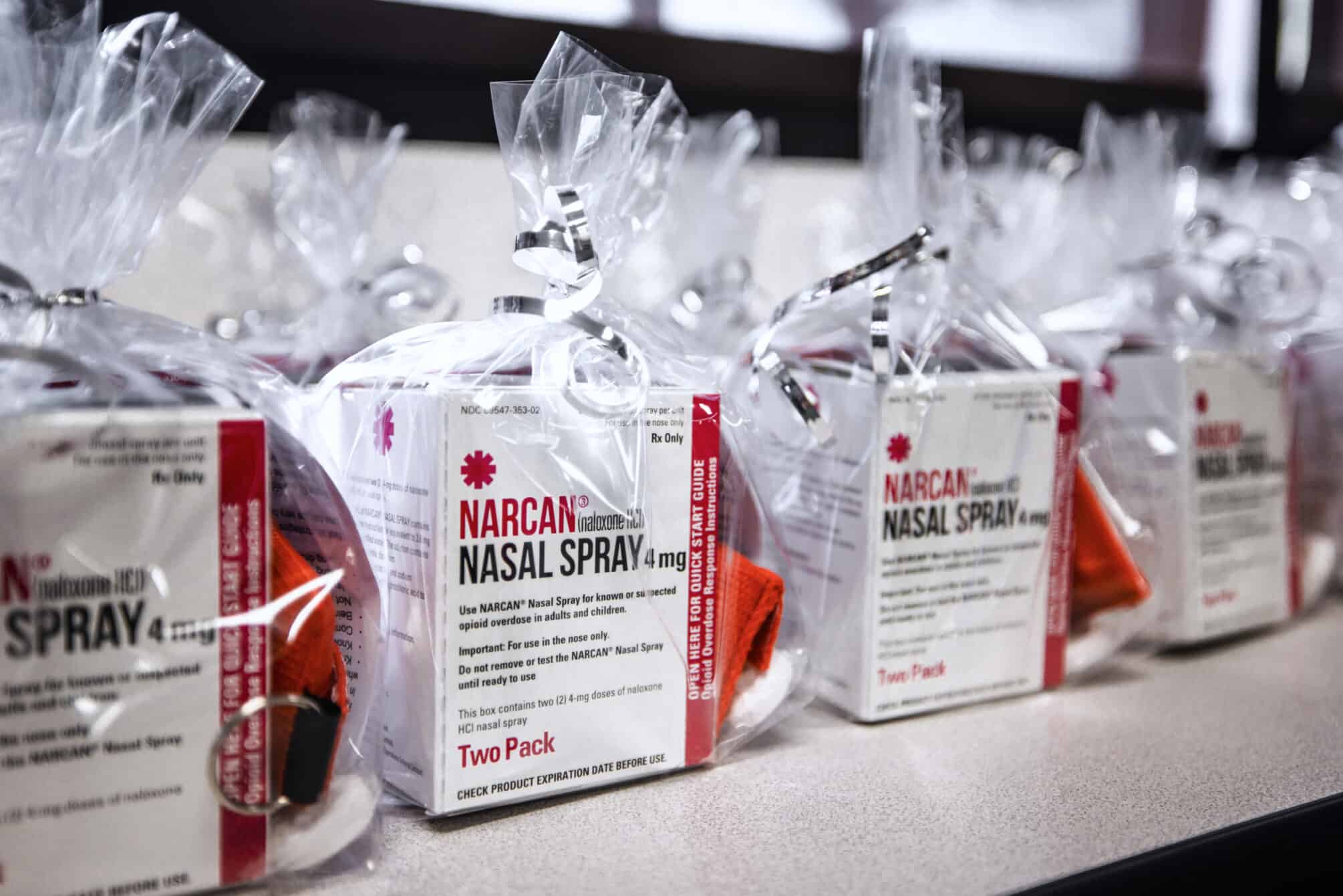 Gift bags containing Narcan and CPR mouth barriers.