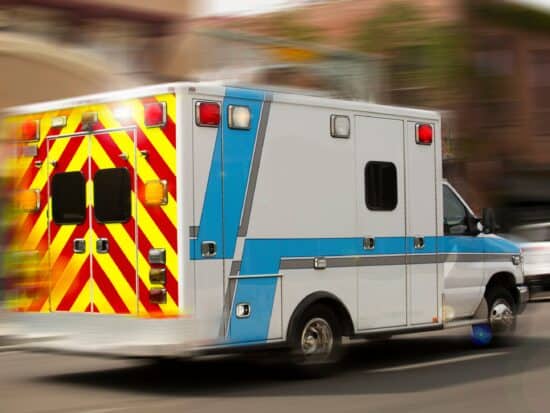 Ambulance driving to scene of heart attack or cardiac arrest call to perform high-quality CPR
