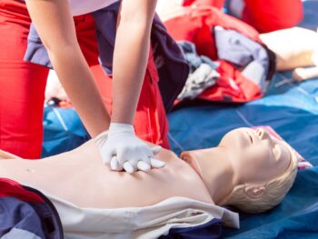 Women performing CPR on a manikin