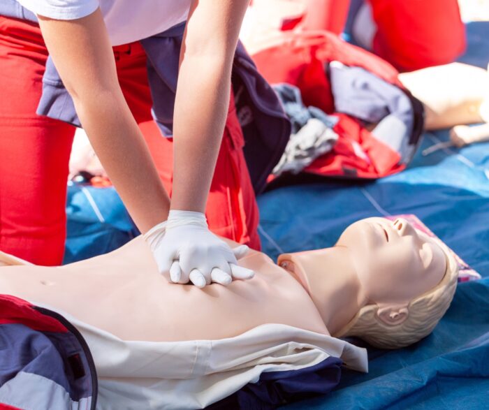 Women performing CPR on a manikin 